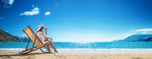 Woman Enjoying Sunbathing at Beach. Summer Vacation