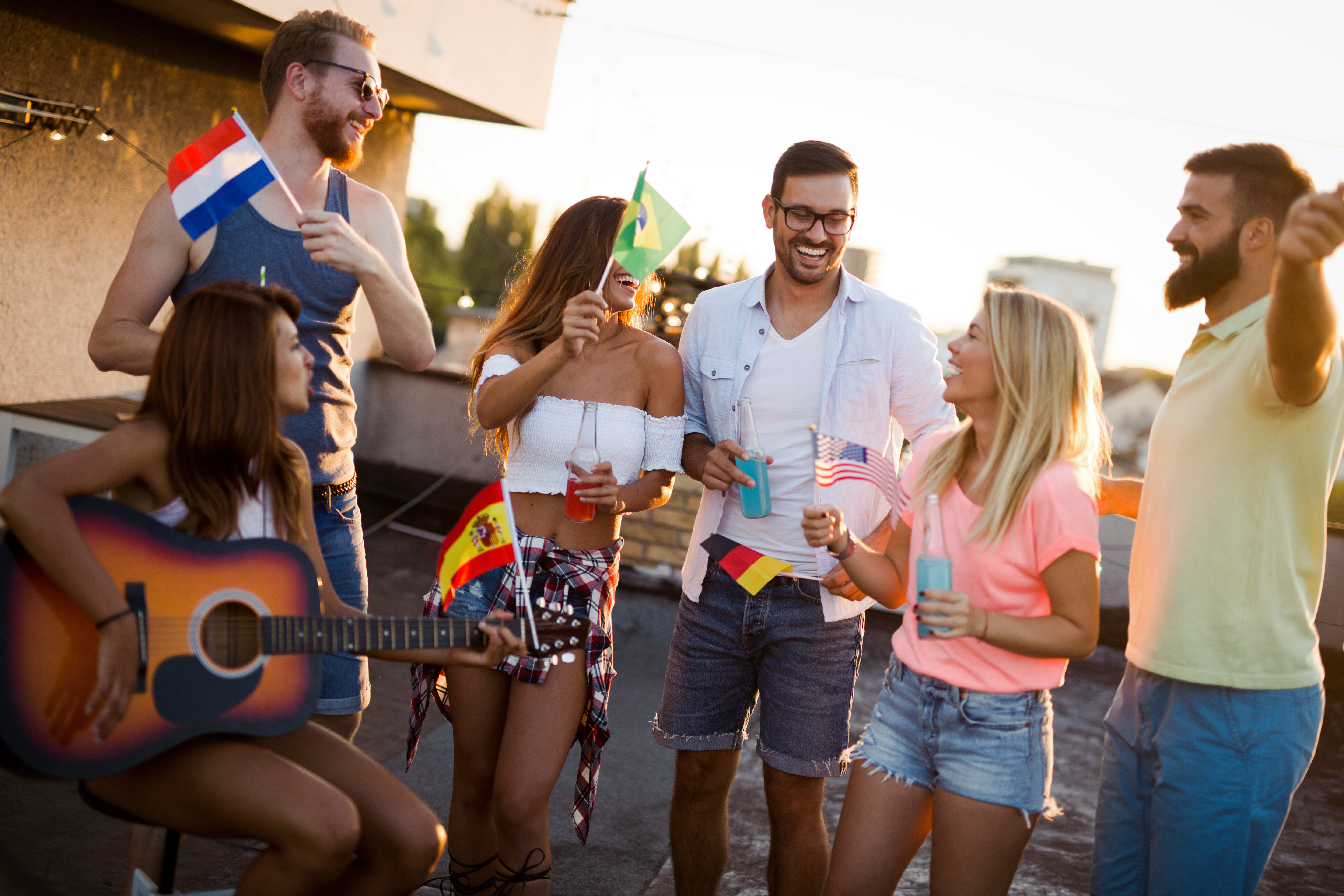 Group of beautiful carefree friends dancing have fun in summer