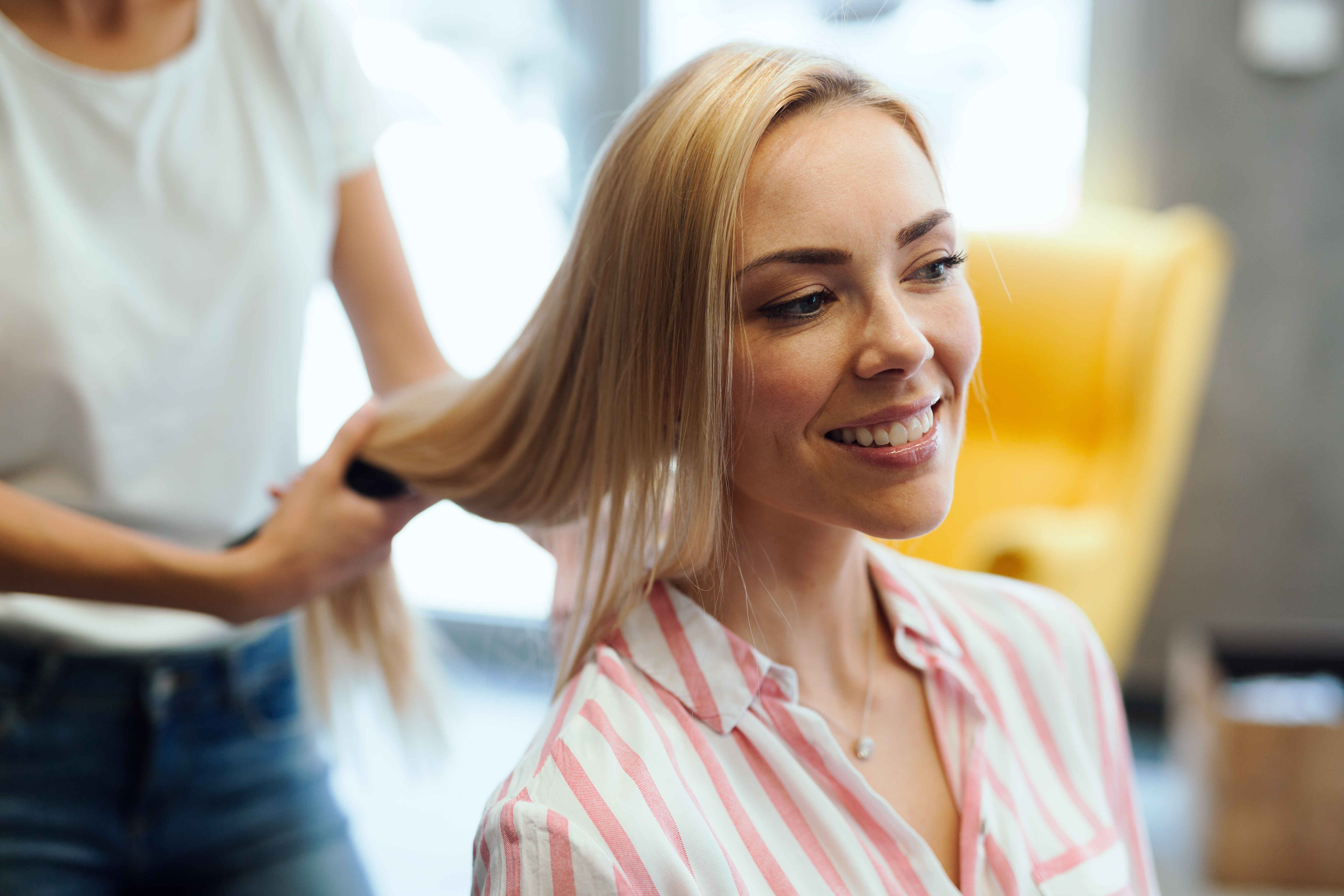 Portrait of a happy woman at the hair salon