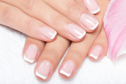 Beautiful woman's nails with french manicure